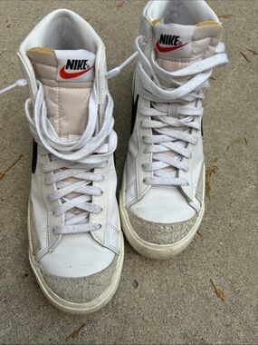 Nike White High-Top Sneakers with Black Swoosh and Red Tongue Logo